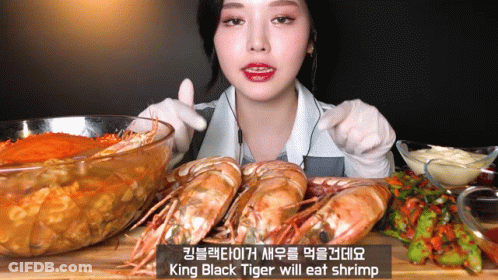 King Black Tiger Will Eat Shrimp On Cutting Board GIF