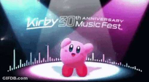 Kirby Is Dancing On A Stage In Front Of A Spotlight At The Kirby 30Th Anniversary Music Fest . GIF