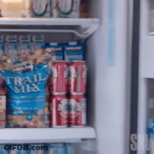 Kirkland Trail Mix Bag On Refrigerator Shelf With Soda Cans GIF