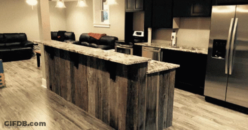 Kitchen With Stainless Steel Appliances And Wooden Counter GIF