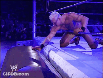 Kneeling Man In Wrestling Ring With W Logo GIF