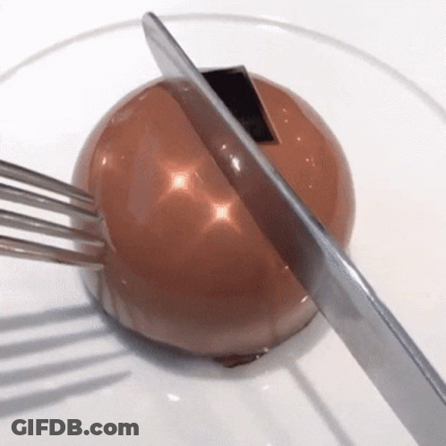 Knife Cutting Chocolate Ball With Fork GIF