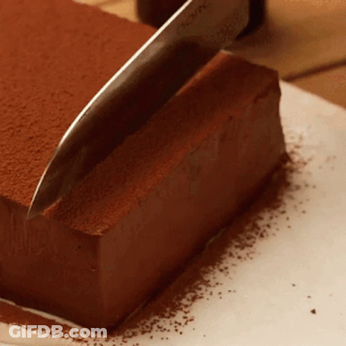 Knife Cutting Chocolate Cake With Cocoa Powder GIF