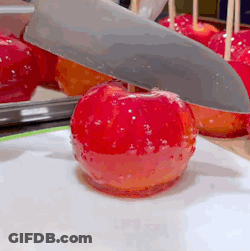 Knife Cutting Red Apple On A Stick GIF