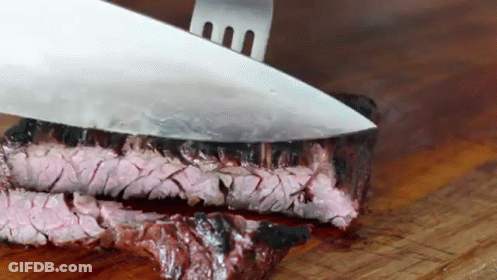 Knife Cutting Steak On Wooden Board GIF