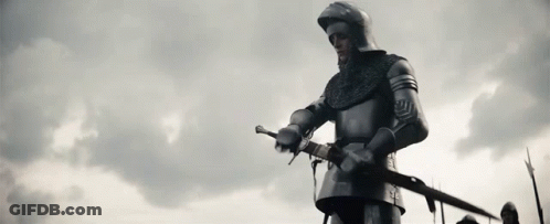 Knight In Armor Holding Sword Before Cloudy Sky GIF