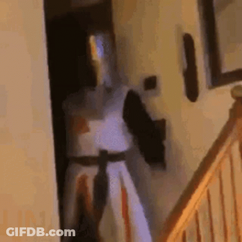 Knight In Armor Standing By Doorway GIF