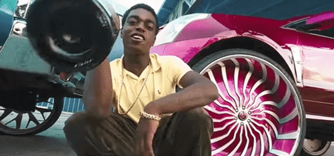 Kodak Black Holding Champagne Bottle With Cars GIF