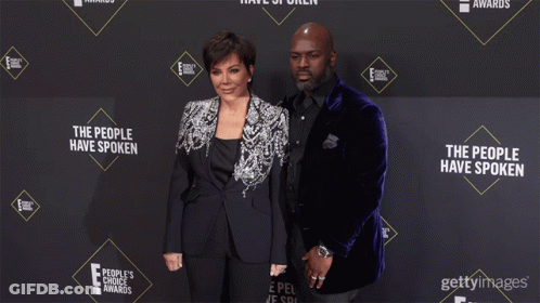 Kris Jenner And Her Husband Pose On A Red Carpet For The People 'S Choice Awards GIF