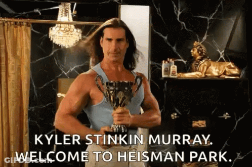 Kyler Stinkin Murray Is Holding A Trophy In A Bathroom And Saying Welcome To Heisman Park . GIF