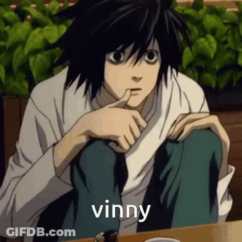 L From Death Note Is Sitting At A Table With His Finger In His Mouth And The Word Vinny Above Him GIF