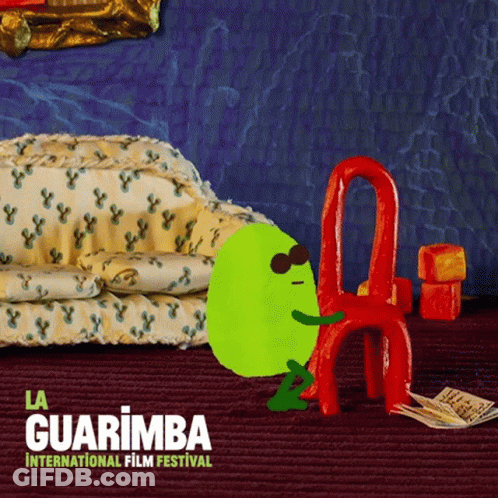 La Guarimba International Film Festival Green Character Sitting On Red Chair GIF