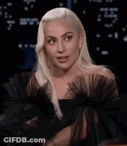 Lady Gaga In Black Dress With Ruffled Sleeves And Earrings GIF