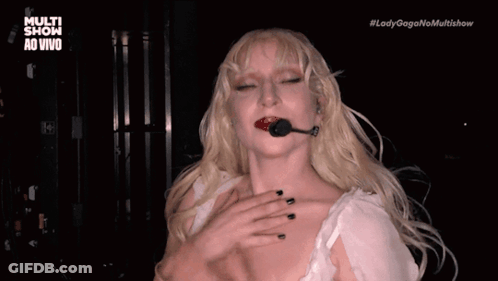 Lady Gaga In Black Dress With Ruffled Sleeves And Earrings GIF
