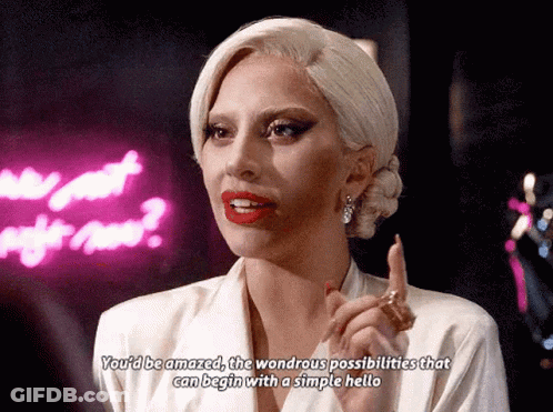 Lady Gaga Says You'd Be Amazed The Wondrous Possibilities That Can Begin With A Simple Hello In Front Of Neon Sign GIF