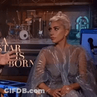 Lady Gaga Sitting In Front Of A Star Is Born Sign GIF