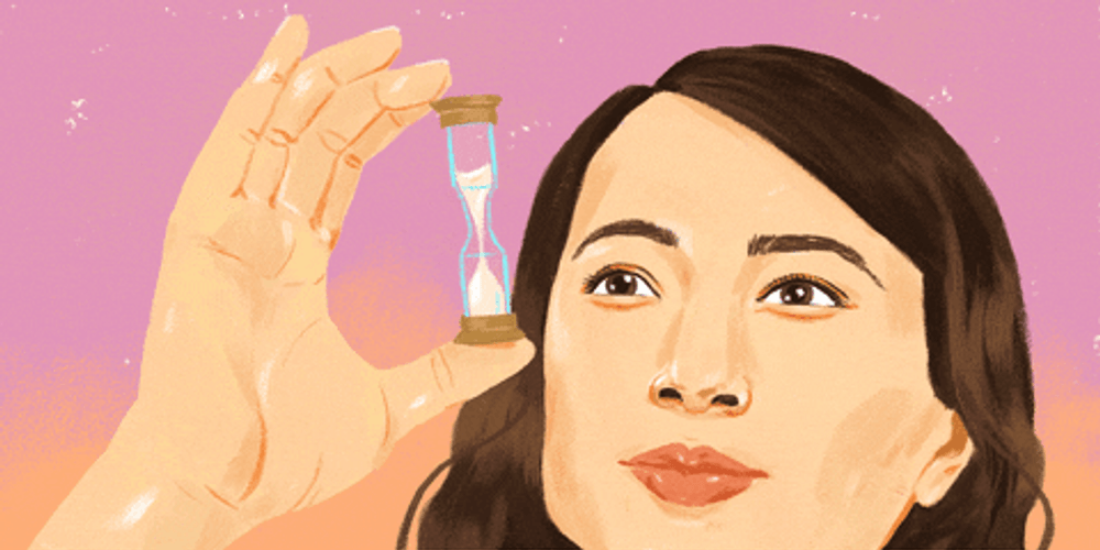 Lady Inspecting Tiny Hourglass GIF