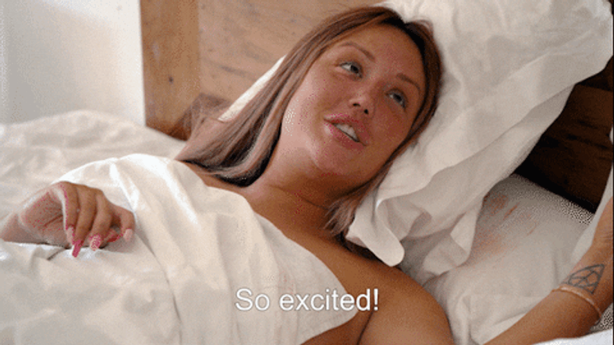 Lady Lying On Bed So Excited GIF