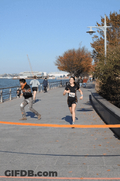 Lady Runner Happily Reaching Finish Line GIF