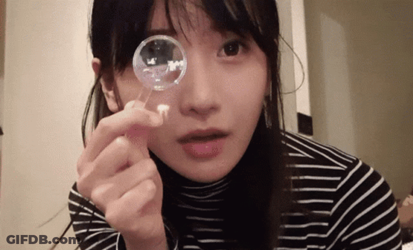 Lady Using Small Magnifying Glass GIF