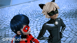 Ladybug And Cat Noir Standing On Cobblestone Street GIF