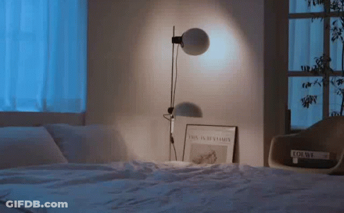 Lamp On Bed Next To Book Loewe GIF