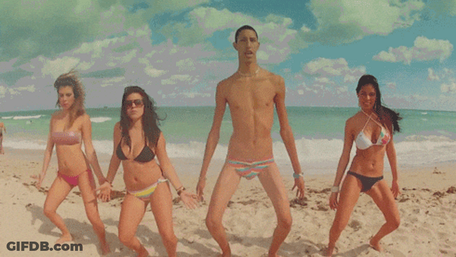 Lanky Man Dancing With Girls On Beach GIF