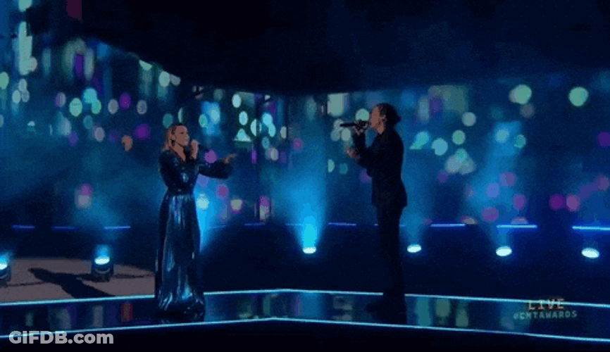 Lanky Man Sings On Stage GIF