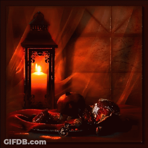 Lantern With Lit Candle On Table GIF