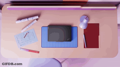 Laptop On Desk Next To Lamp And Folder GIF