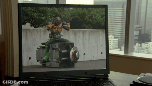 Laptop Showing Man In Superhero Costume GIF