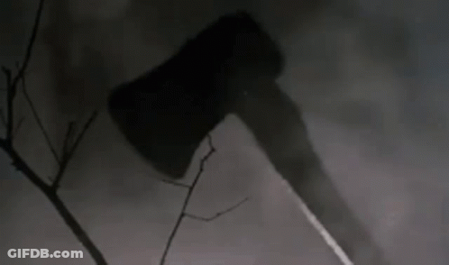 Large Axe Hanging From Tree Branch In Dark Forest GIF
