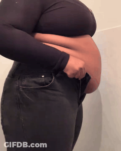 Large-Bellied Woman In Black Jeans And Crop Top GIF