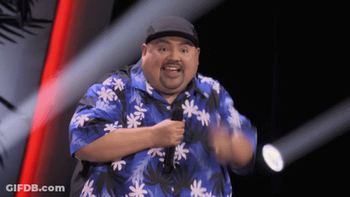 Large Black Truck Driving Next To Race Car GIF