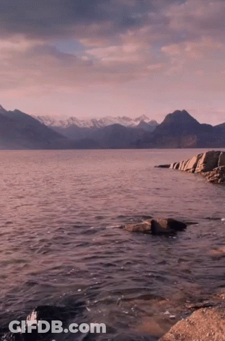 Large Body Of Water With Mountains And Rocks GIF