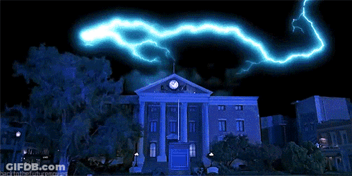 Large Building With Clock And Lightning GIF