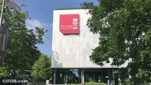 Large Building With Red Staffordshire University Sign GIF