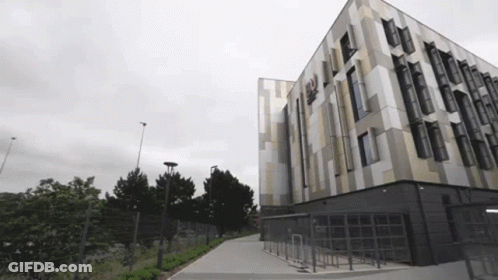 Large Building With Windows And Fence GIF