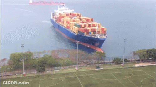 Large Container Ship Floating In Ocean GIF