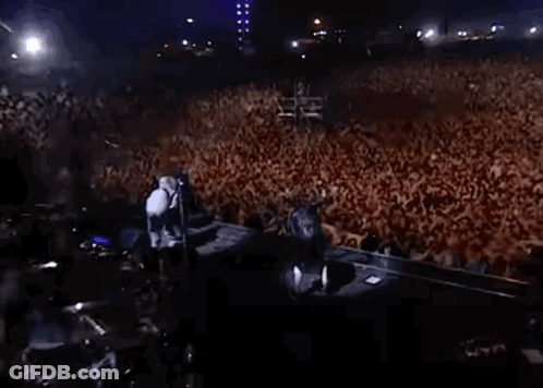 Large Crowd Gathered In Dark Room GIF