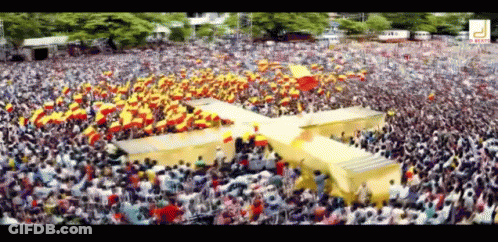 Large Crowd In Stadium With Yellow Cross GIF