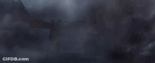 Large Dragon Flying Through Foggy Sky GIF