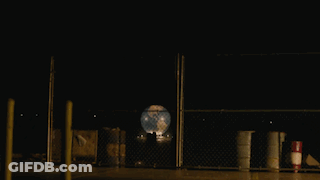 Large Explosion Behind Fence In Parking Lot GIF