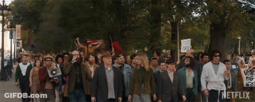 Large Group Marching With Netflix Sign GIF