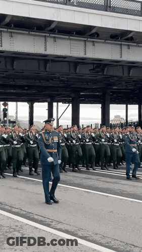 Large Group Of Soldiers Marching Down Street GIF