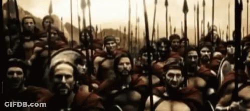 Large Group Of Soldiers With Spears And Shields Standing In A Line GIF