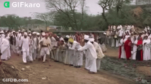 Large Group On Dirt Road In Field GIF