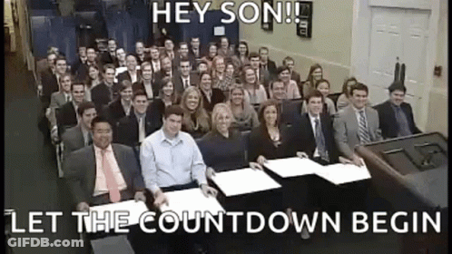 Large Group Sitting In Room Saying Hey Son Let The Countdown Begin GIF