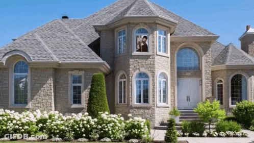 Large House With Gray Roof And Man Woman In Window GIF