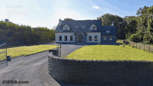 Large House With Stone Wall And Driveway GIF